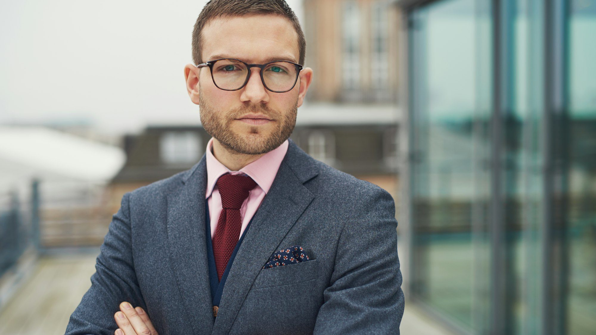 Confident businessman standing outside office